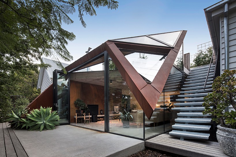 angular corten roof  folds down over leaf house  extension 