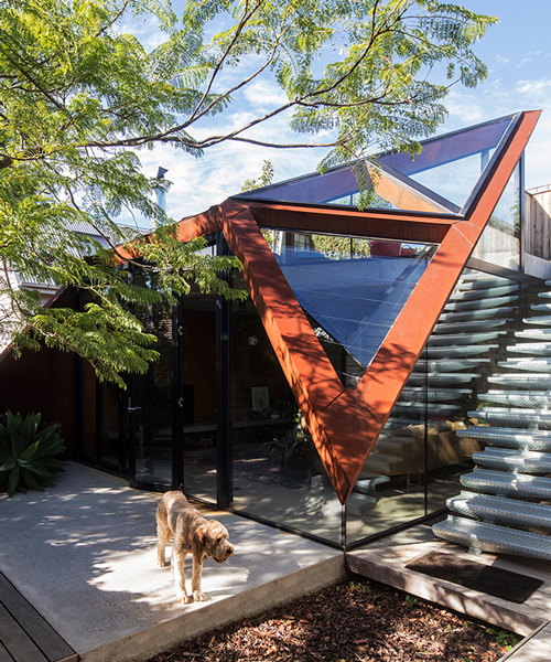 angular corten roof folds down over leaf house extension in melbourne