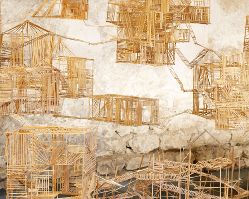 sara favriau carves a delicate wooden cityscape at domaine de chaumont-sur-loire