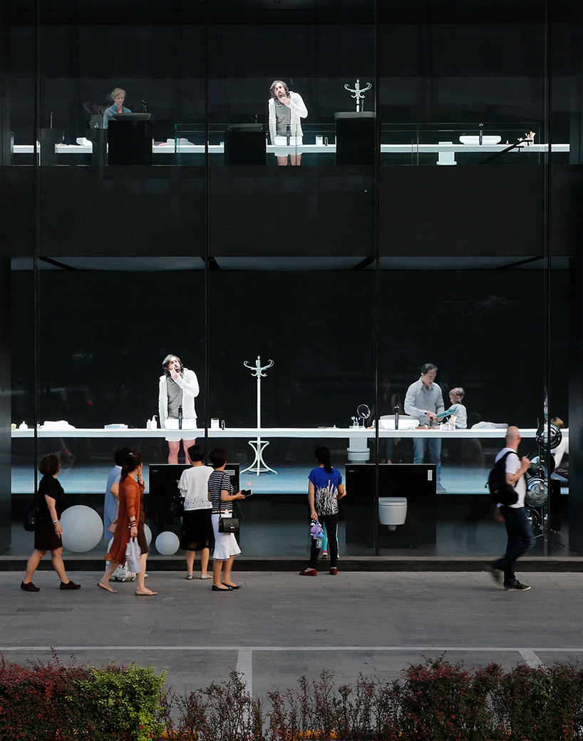 MAD projects simulations of people on LED screens inside roca beijing gallery