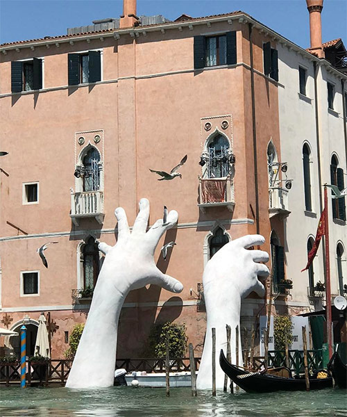 lorenzo quinn's support sculpture braces ca' sagredo hotel at the venice art biennale