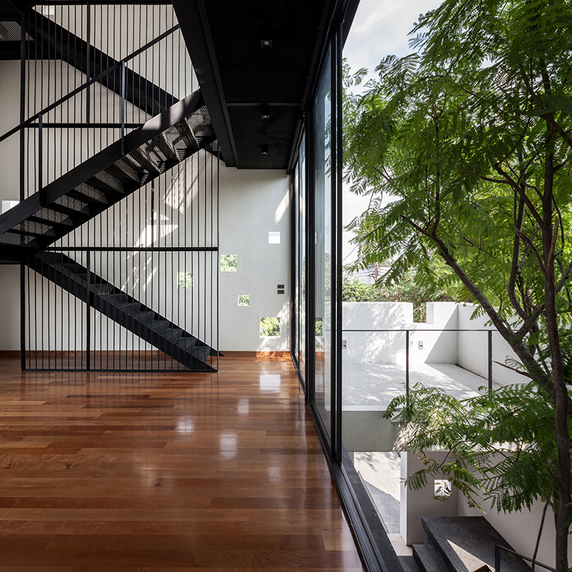 Stu/D/O architects carves openings throughout the façade of bangkok house