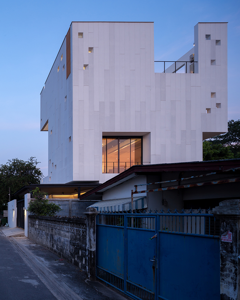 Stu/D/O architects carves openings throughout the façade of bangkok house