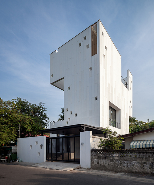 Stu/D/O architects carves openings throughout the façade of bangkok house