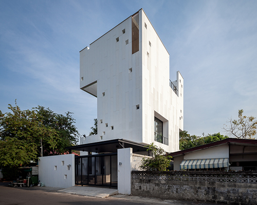 Stu/D/O architects carves openings throughout the façade of bangkok house