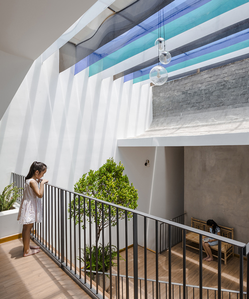 23o5 studio's tinted veranda playfully colorizes the 'loc house' in vietnam