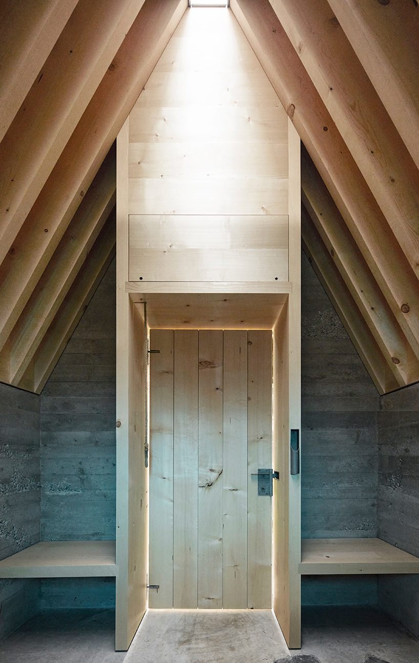 innauer matt's tiny alpine chapel is perched along a scenic austrian meadow