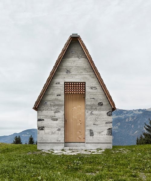 innauer matt's tiny alpine chapel is perched along a scenic austrian meadow