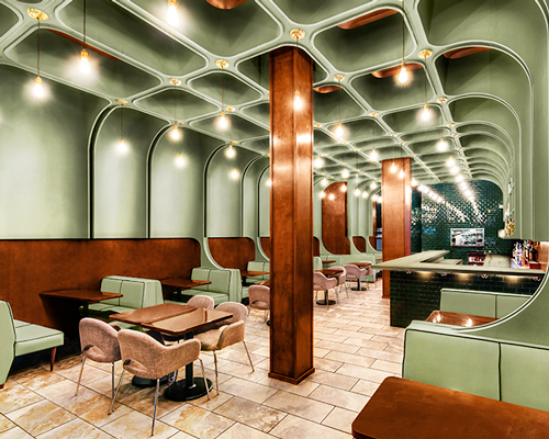 bluarch wraps times square diner with soft green interior in new york