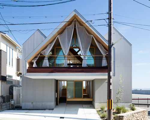 hiroto kawaguchi+kohei yukawa's wood-clad newtown house overlooks the picturesque japanese landscape