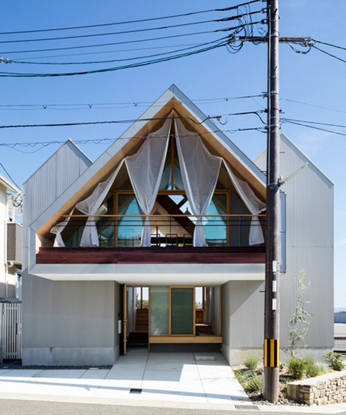hiroto kawaguchi+kohei yukawa's wood-clad newtown house overlooks the picturesque japanese landscape