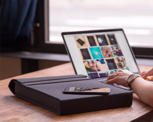the LAER bluetooth sleeve charges your phone and laptop on the go