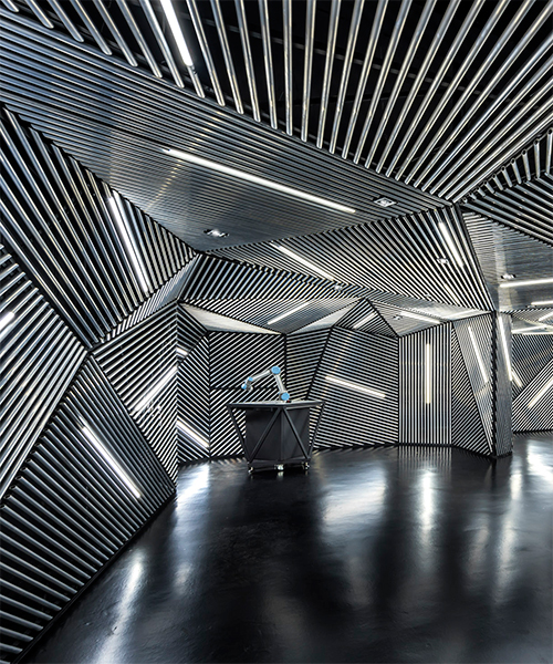 ministry of design's robotic facility in singapore features a hypnotic metallic skin