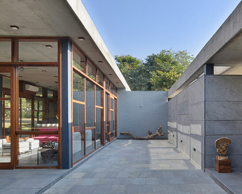 the house by the trees integrates the surrounding indian nature within the residence