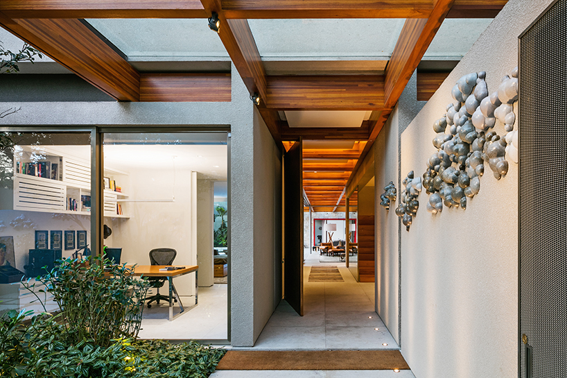 perkins + will builds a tropical house around a tree in são paulo