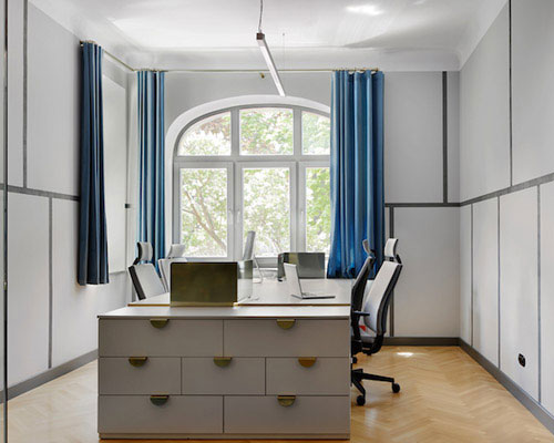 beza interiors revamps hand made's office using trademark gold and blue colors