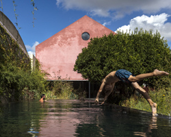 extrastudio transforms historic winery in portugal into secluded house with red mortar walls