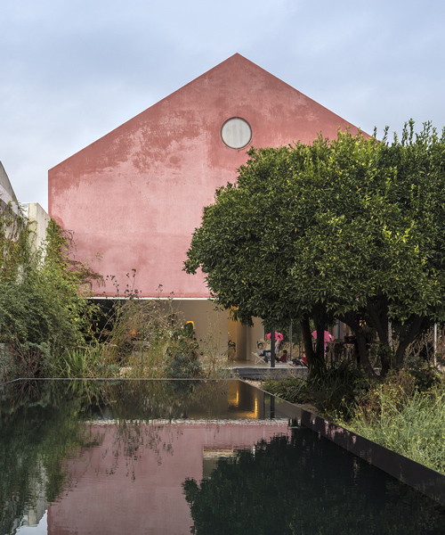 extrastudio transforms historic winery in portugal into secluded house with red mortar walls