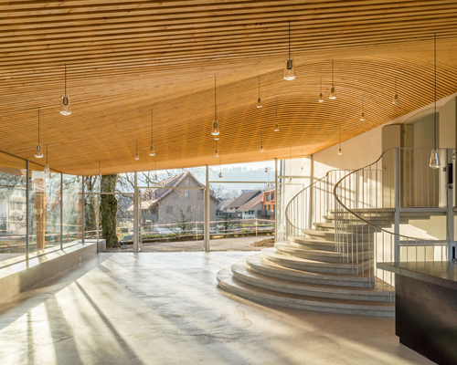 gian salis adds light-filled foyer to historic church in switzerland