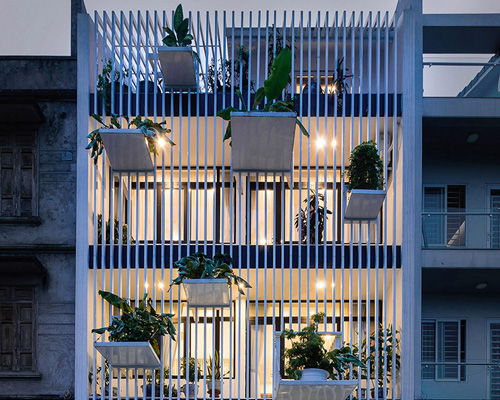 DANstudio suspends tree-filled 'balconies' from the façade of a private house in hanoi