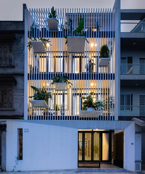 DANstudio suspends tree-filled 'balconies' from the façade of a private house in hanoi