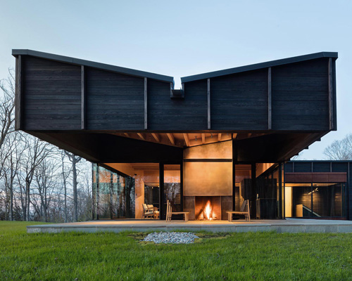 desai chia unites three offset structures to form charred timber lake house in michigan
