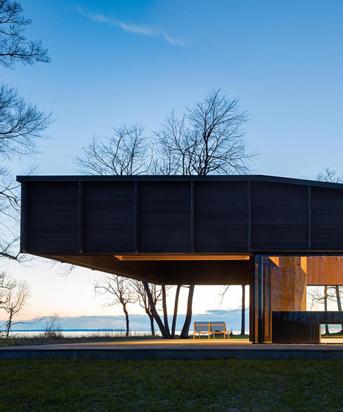 desai chia unites three offset structures to form charred timber lake house in michigan