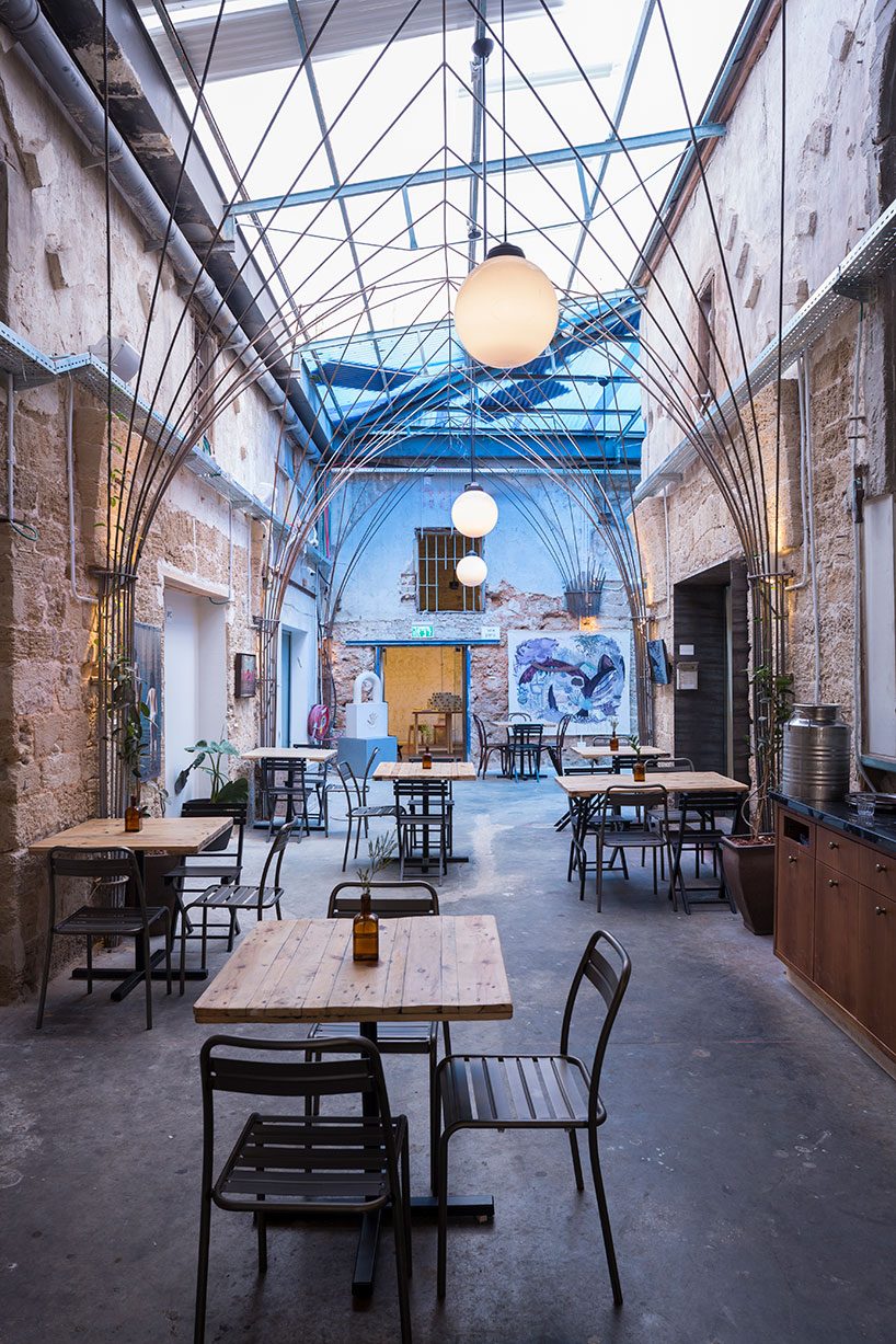 opa architects repurpose war-torn house into a rustic resto-pub in jeffa