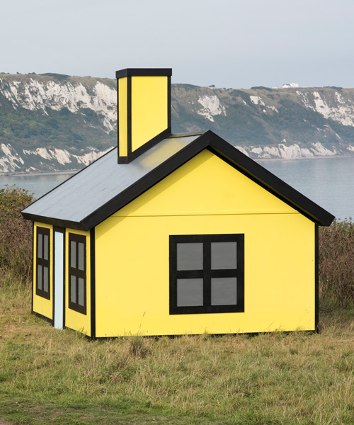 richard woods' bold and bright 'holiday homes' dot an english town with pops of color