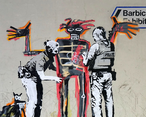 banksy welcomes barbican visitors into basquiat exhibit with politically charged graffiti