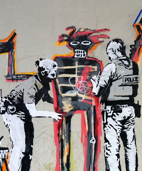banksy welcomes barbican visitors into basquiat exhibit with politically charged graffiti