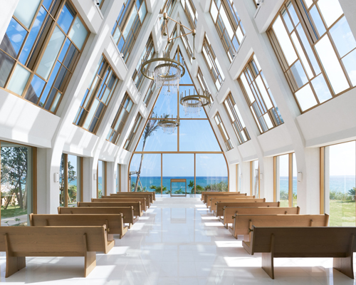 general design's light-filled wedding chapel in ginoza frames views of the japanese coast
