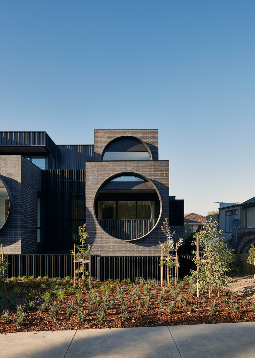 bkk architects frames cirqua apartments near melbourne with oversized, circular windows