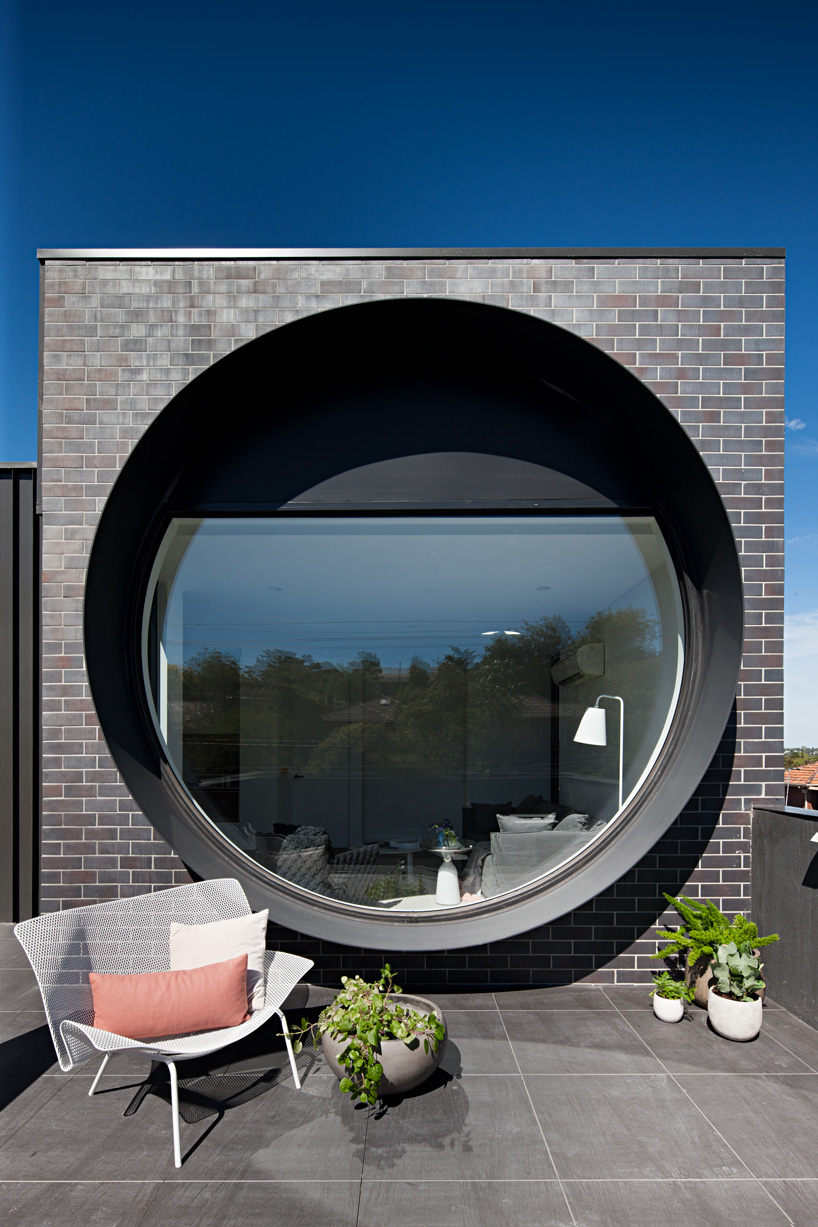 bkk architects frames cirqua apartments near melbourne with oversized, circular windows