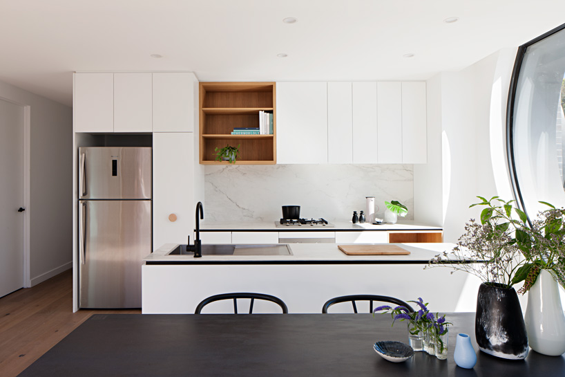 bkk architects frames cirqua apartments near melbourne with oversized, circular windows