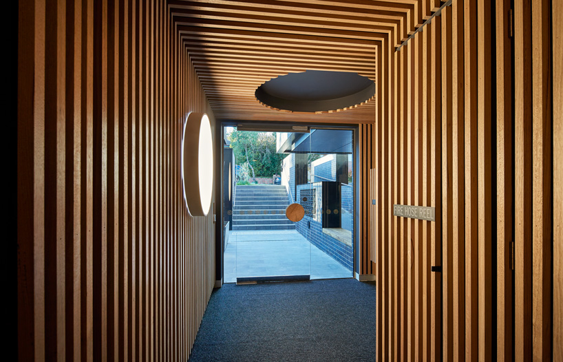 bkk architects frames cirqua apartments near melbourne with oversized, circular windows