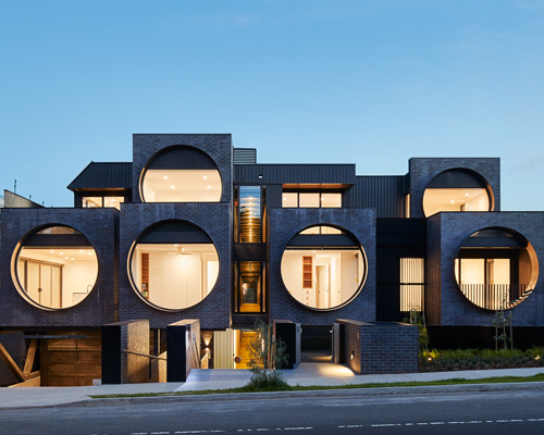 bkk architects frames cirqua apartments near melbourne with oversized, circular windows