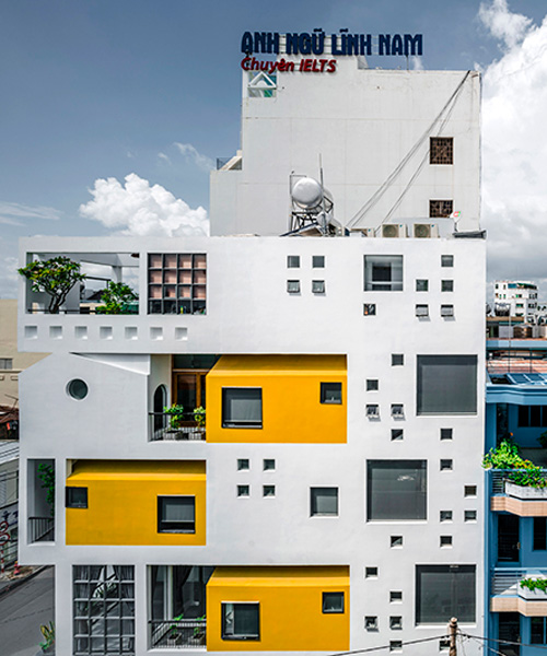 23o5 studio's HVB complex in vietnam comprises tree-filled voids and bright yellow volumes