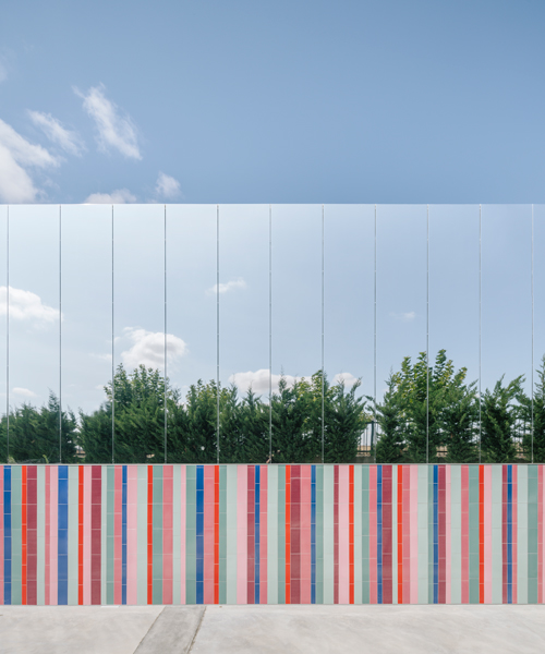 ABLM combines reflective mirrors with strips of vibrant colorful ceramic in school façade