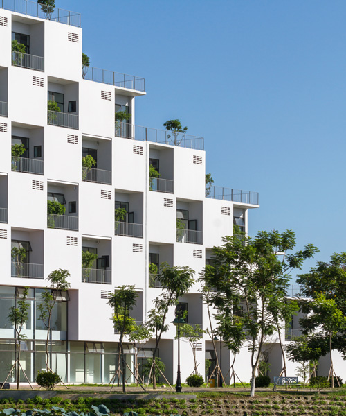 checkerboard façade of VTN's hanoi university building contains trees within recessed voids