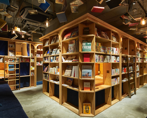 book and bed hotel welcomes guest to sleep among the bookshelves after a bedtime story