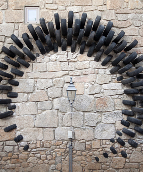 cumul's installation in portugal is made with tires and placed upon an urban landscape