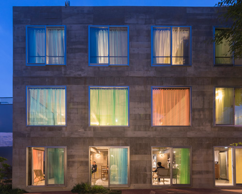 tato architects animates retro hotel in japan with colorful curtains and eclectic furnishings
