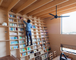 shinsuke fujii designs integrated oblique wall for the 'bookshelf house' in yokohama