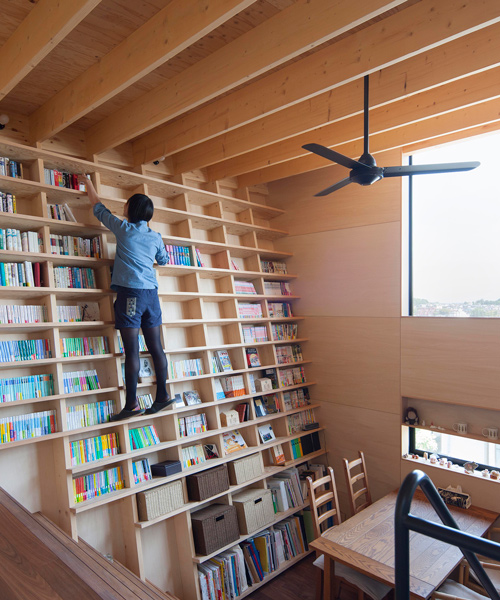 shinsuke fujii designs integrated oblique wall for the 'bookshelf house' in yokohama