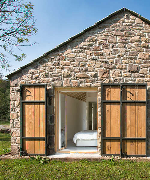 laura alvarez architecture transforms stone shed into a rustic holiday retreat in cantabria