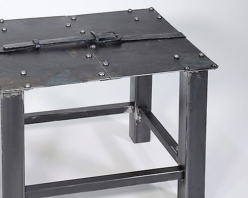 medieval inspired metal-forged table is hugged by an iron belt