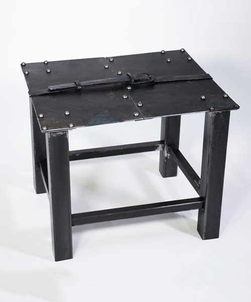 medieval inspired metal-forged table is hugged by an iron belt