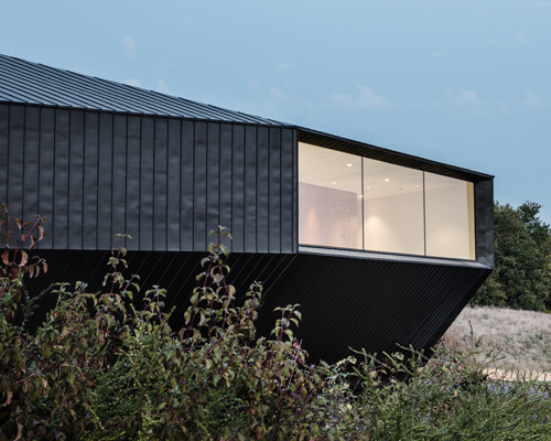 tetrarc embeds monolithic convention center into the landscape of southwestern france