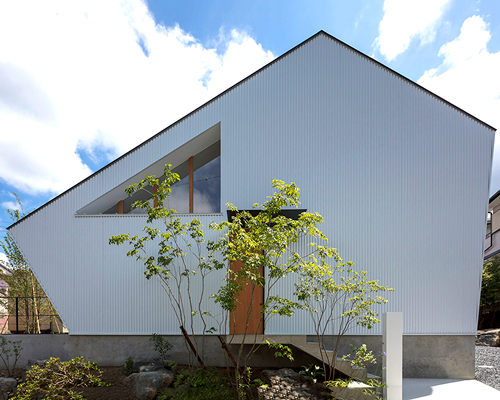 arbol design incorporates angular gabled roof in quaint japanese home